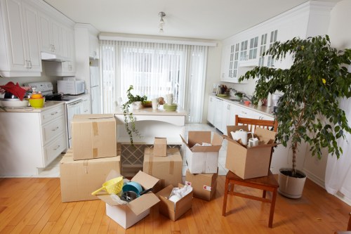 Removal workers handling items in a Bermondsey flat with narrow access