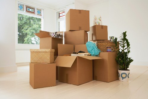 Trained movers handling boxes carefully in a Bermondsey property